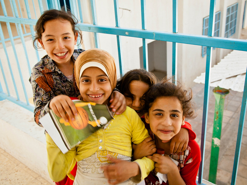 A group of girls huddle together for a photo at the women's centre in Jordan's Jerash Camp for refugees from Gaza. (Pic credit: Omar Chatriwala/Flickr)