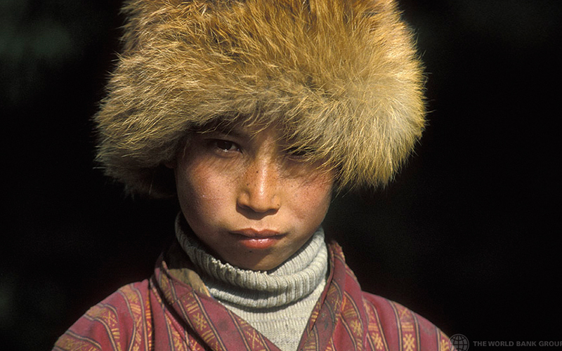 Portrait of young boy wearing fur hat in Bhutan ( (Photo credit: Curt Carnemark / World Bank)