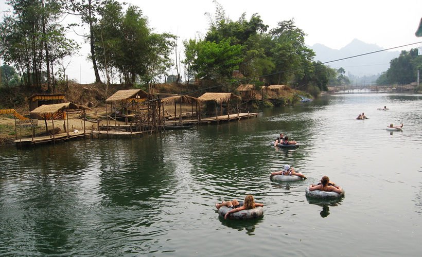 Tubing down Nam Song River. (Photo Credit: Flickr / Chris Feser)