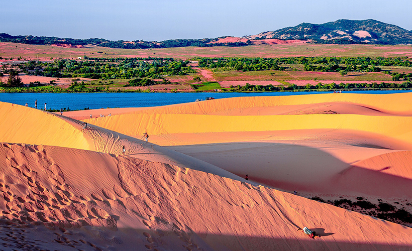 Go sandboarding on the red dunes of Mui Ne