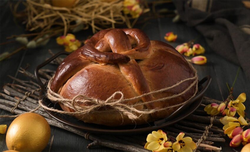 Traditional Folar da Páscoa Easter bread with a hard-boiled egg on top.
