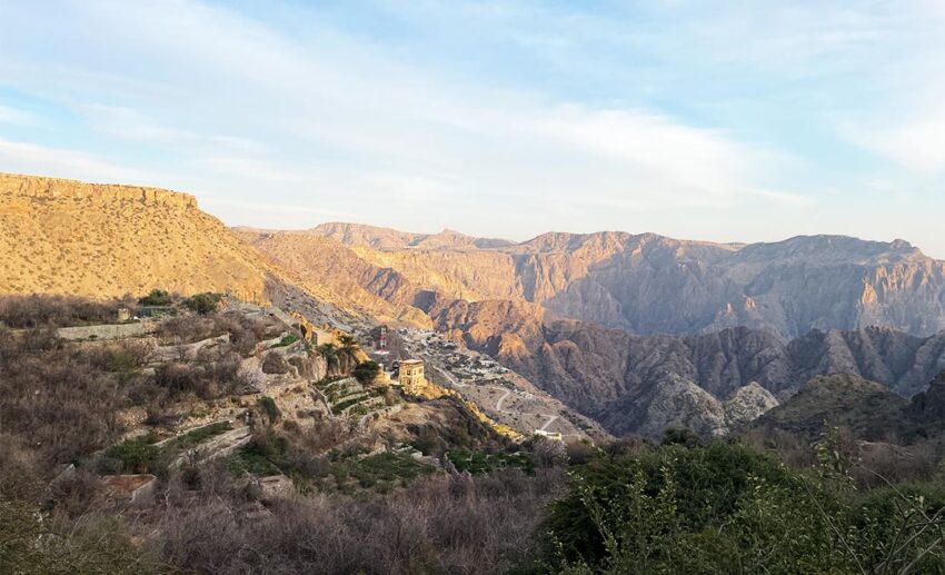 Wide drone-style shot of an ancient mountain village in Jebel Akhdar, the Green Mountain of Oman.
