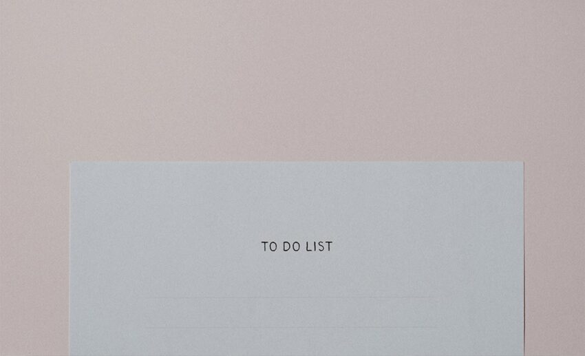 Close-up of the top of a paper to-do list with a checklist header for travel preparation.