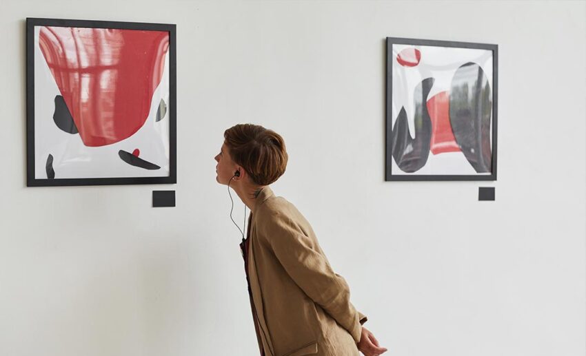 Woman looking at artwork in a quiet museum gallery during a restorative relaxed afternoon.