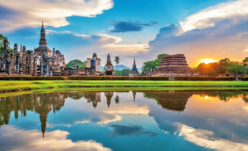 Ancient Buddha statue at Wat Mahathat Temple in Sukhothai Historical Park, a UNESCO World Heritage site reachable via the Emirates Asia Pass.