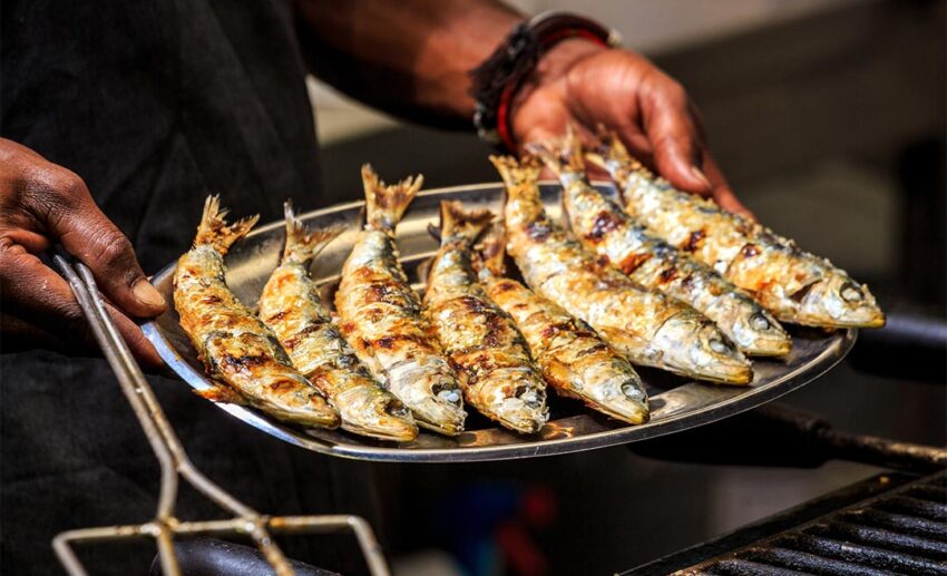 Freshly grilled sardines on bread at a Lisbon street festival (Festas de Santo António).