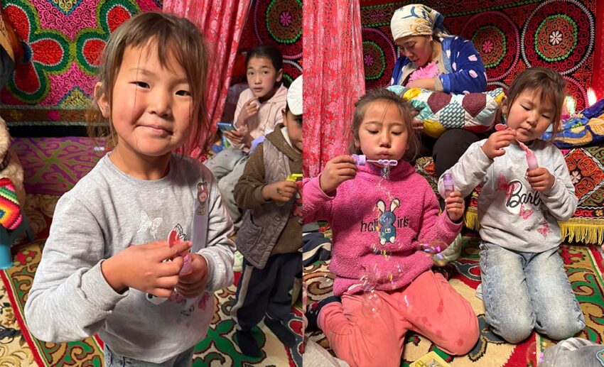 Young nomad children in Mongolia laughing and playing with bubbles, a gift from the author.