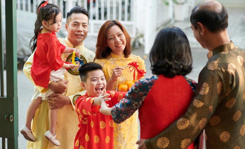 A family of four arriving at an elder’s home with gifts to celebrate Chap Goh Meh, the final night of the Lunar New Year.