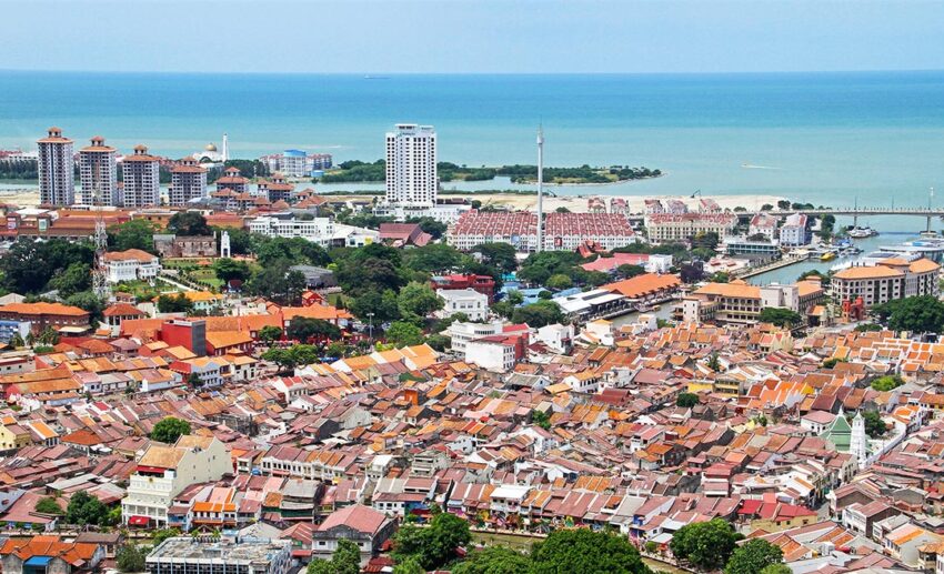 A sweeping bird’s-eye view of the historic town of Melaka, a UNESCO World Heritage Site, showing colonial architecture and modern developments.