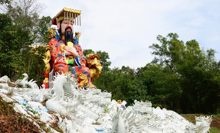 A large, ornate statue of the Jade Emperor at a Taoist temple.