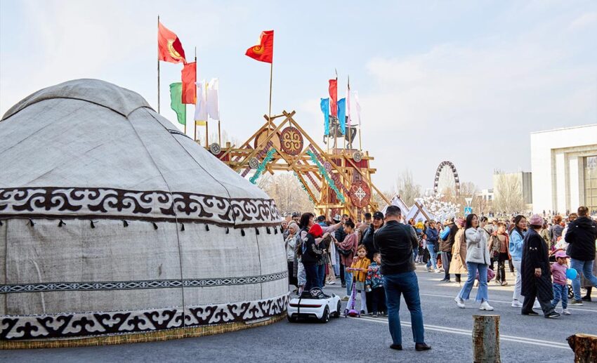 A crowd gathered around a traditional nomadic yurt on Ala-Too Square during a public holiday celebration in Bishkek.