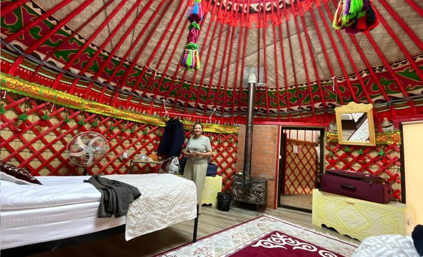 Sofia’s mother inside a luxury yurt accommodation featuring traditional Kyrgyz textiles and modern comforts.