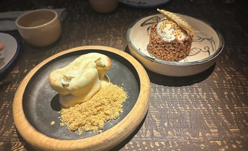 A variety of authentic Kazakh halal dishes served on ornate plates at Yurta restaurant.