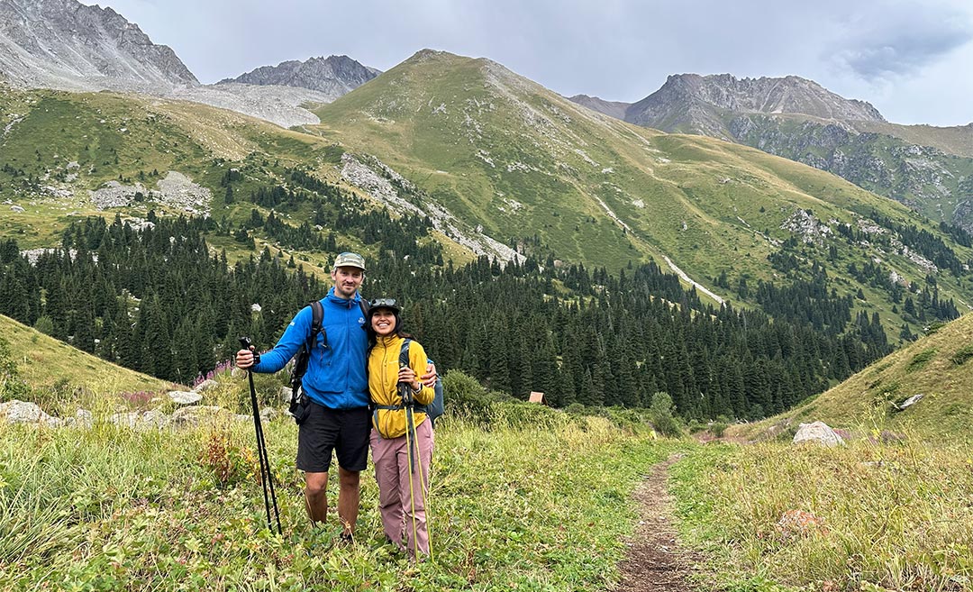 Sofia and her partner pausing for a photo on a rocky trail midway through the Big Almaty Peak hike in Polyana Terra, Kazakhstan.