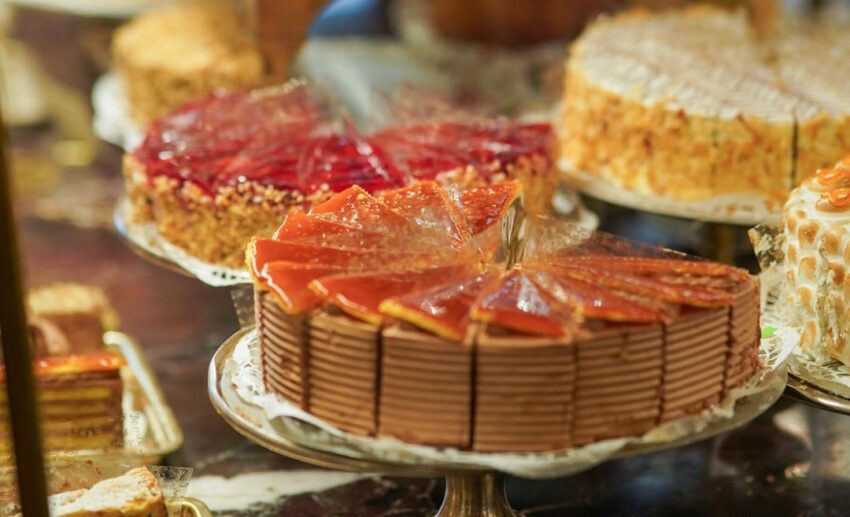 A tempting display of artisan cakes, tarts, and traditional Viennese pastries on the counter at Café Demel.