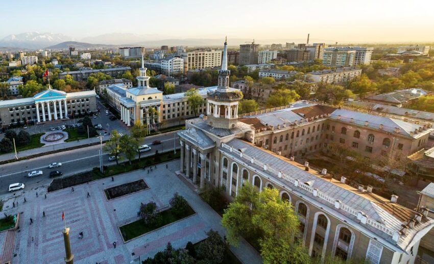 Aerial view of Bishkek city, showing the square near City Hall and the historic 1954 International University of Kyrgyzstan building.