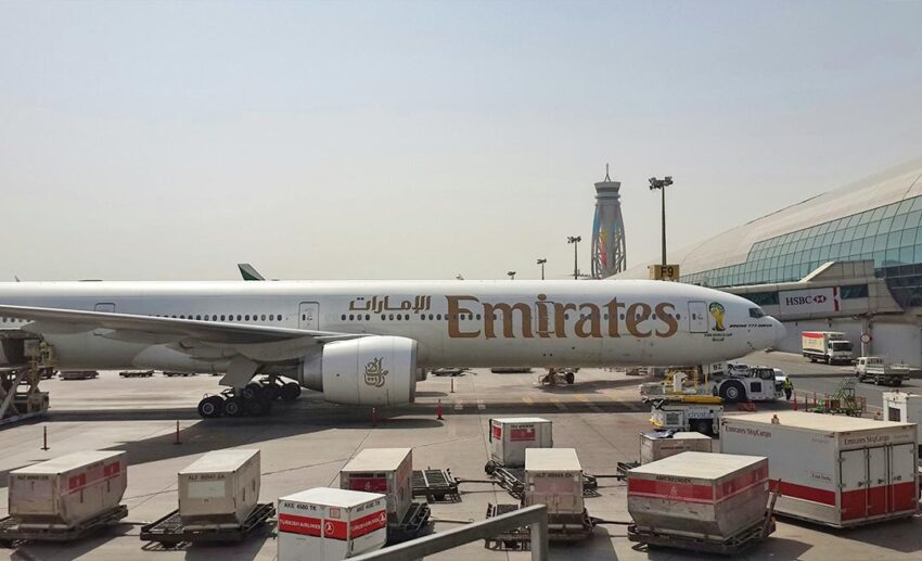 An Emirates Boeing 777 jetliner parked on the airport tarmac at Dubai International Airport (DXB) in the United Arab Emirates.