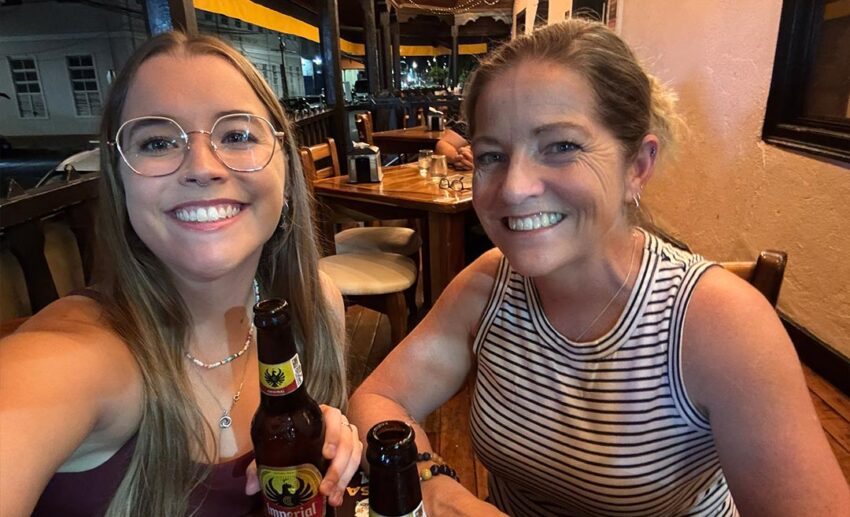 A personal milestone: the writer and her mother smiling as they share their first glasses of Imperial, the national beer of Costa Rica.