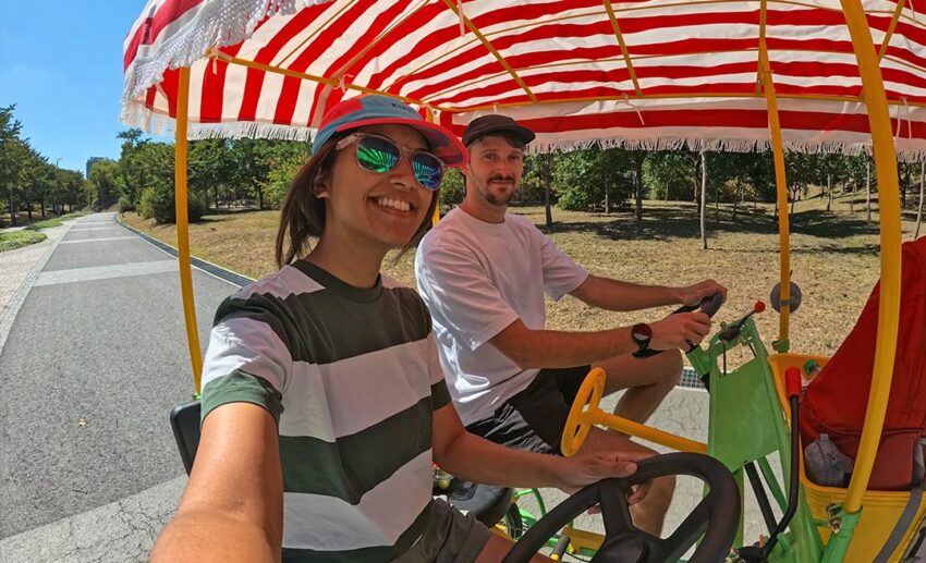 The writer and her partner riding a two-person tandem bicycle along the paved paths of Yeouido Hangang Park in Seoul.