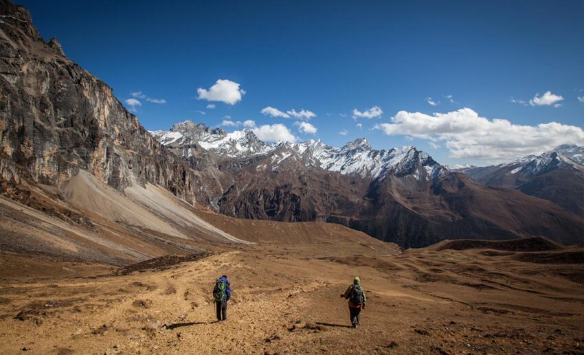 Group of hikers walking through the scenic mountain trails of Paro, Bhutan, during a trekking expedition.