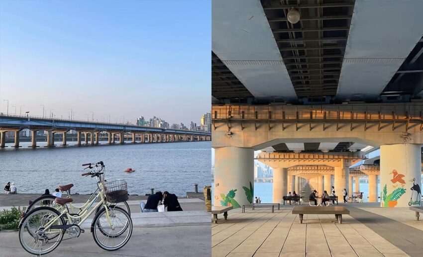 Bicycles parked by the Han River and people relaxing at picnic tables in the shade under a bridge.