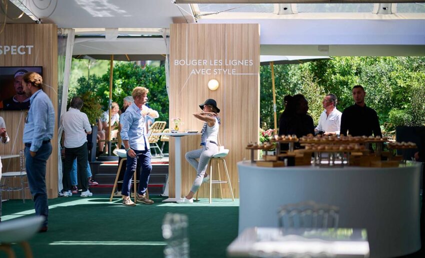 The luxury interior of a VIP lounge at the Wimbledon tennis championships in London, featuring elegant seating and a view of the grounds.