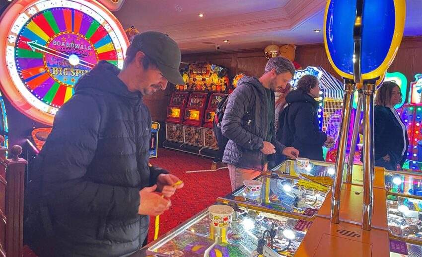 The bright and colourful interior of an amusement arcade in Tenby featuring classic 2p pusher games.