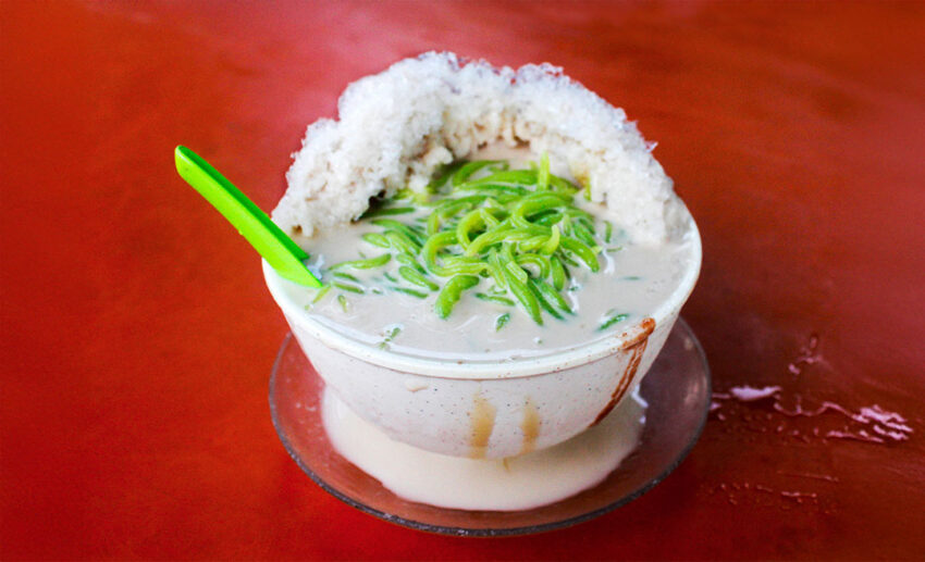 A refreshing bowl of traditional iced Cendol with green jelly and red beans from the famous Ansari Cendol in Taiping.
