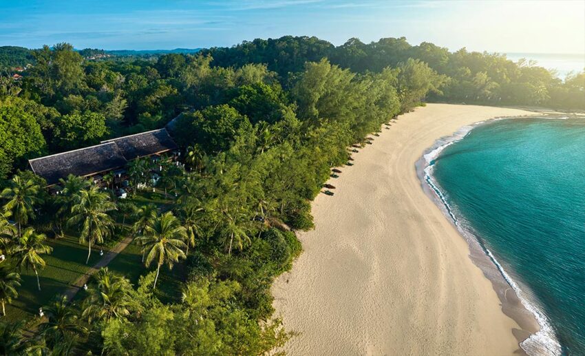 An aerial drone photograph of Tanjong Jara Resort in Terengganu, showing the heritage architecture surrounded by jungle, white sand beaches, and the ocean.