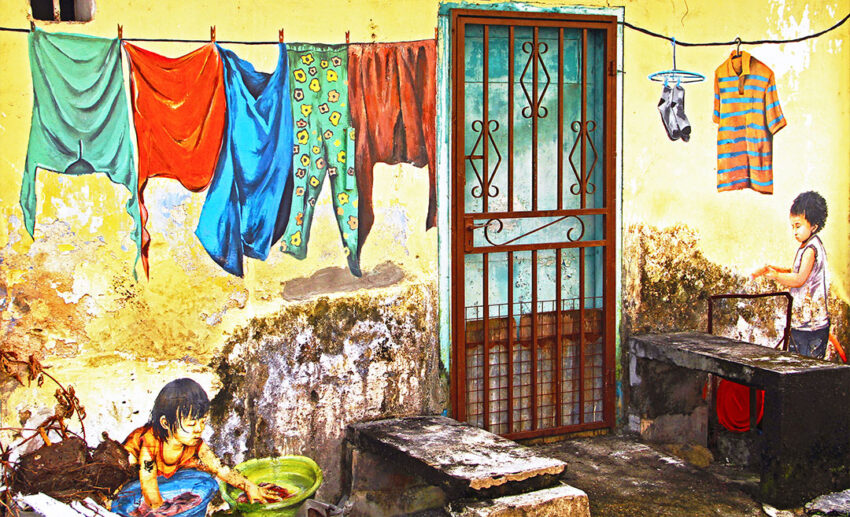 Vibrant and creative street art mural in a narrow alleyway in downtown Taiping, Perak, depicting local history.