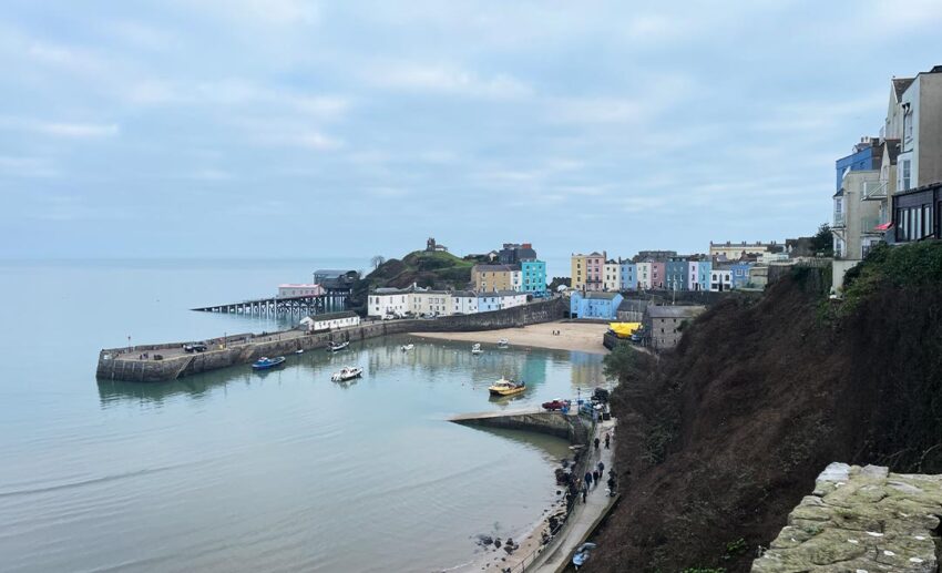 A scenic shot of the historic stone pier and harbour in the seaside town of Tenby, South Wales.