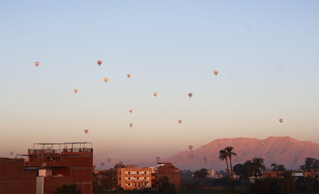 A tranquil 6am view of Luxor, Egypt, with the soft morning light hitting the ancient landscape.