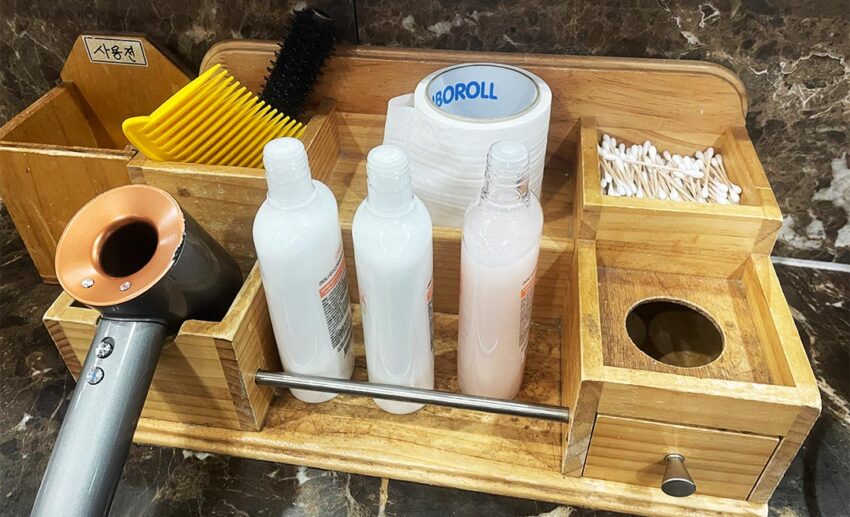 A selection of complimentary toiletries, including combs, hair ties, and skincare products, at a Korean business.
