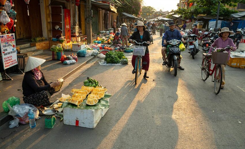 Market traders in Hoi An starting their day in the soft, low morning light before the temperature rises.