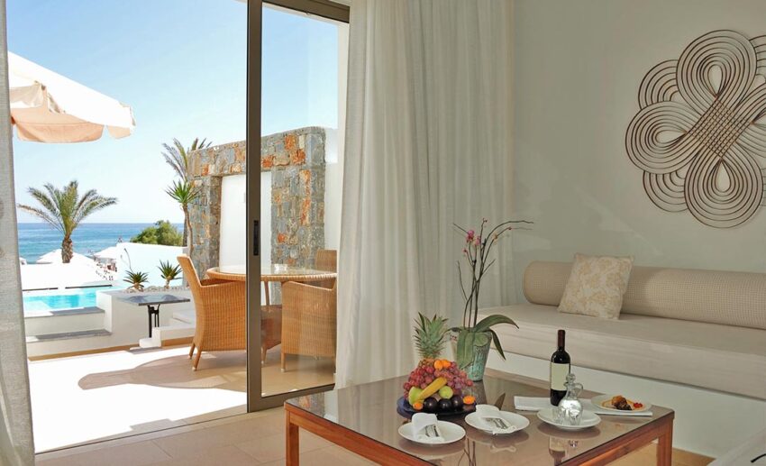 The luxury interior of a villa in Crete, Greece, featuring minimalist design, large windows for ventilation, and breathable bedding.