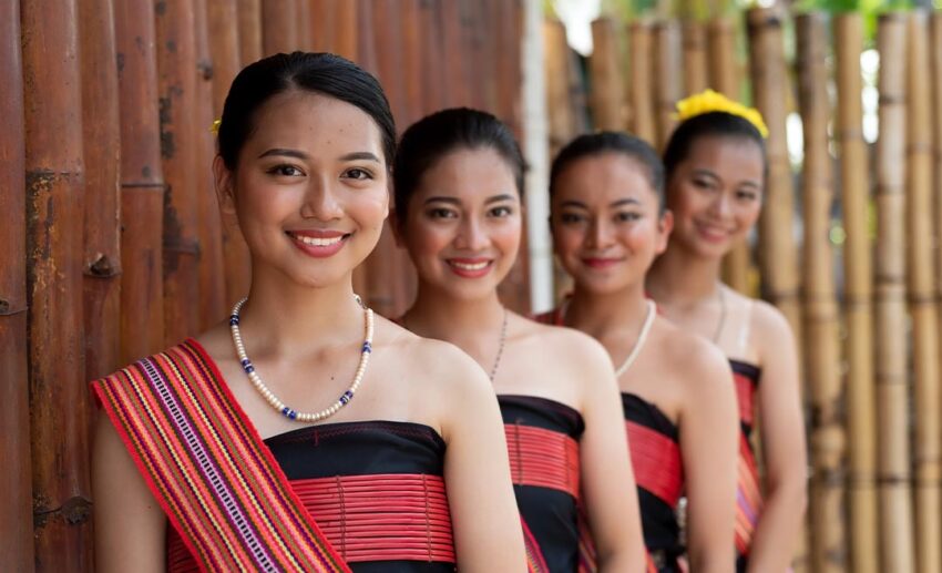 Kadazan Dusun women in traditional Kota Belud district attire attending the state-level Kaamatan Harvest Festival at the KDCA grounds in Kota Kinabalu, Sabah.