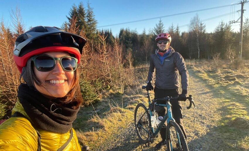 The writer and her partner smiling for a selfie while taking a break during a cycling tour in the Lake District.