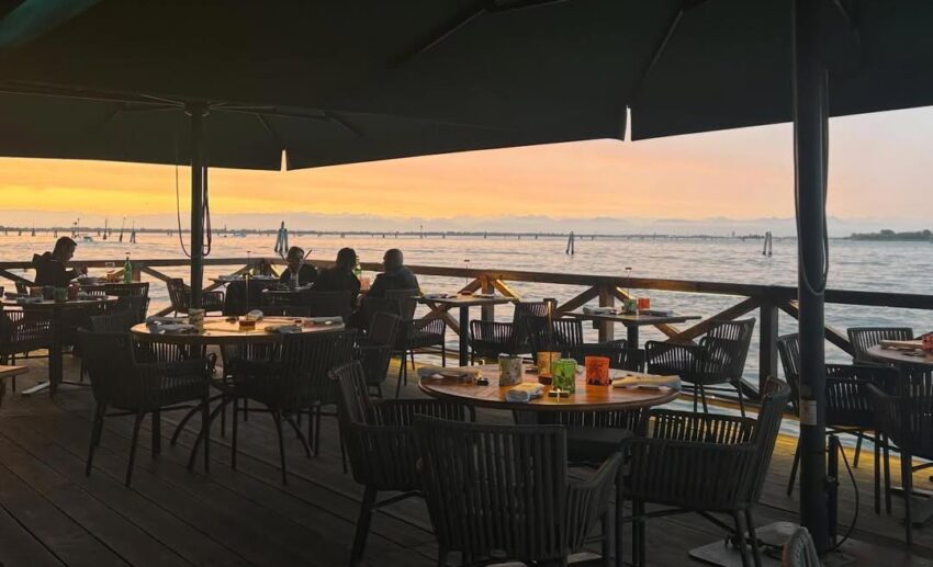 The exterior of Algiubagio restaurant on the Venice waterfront during the quiet early morning hours.