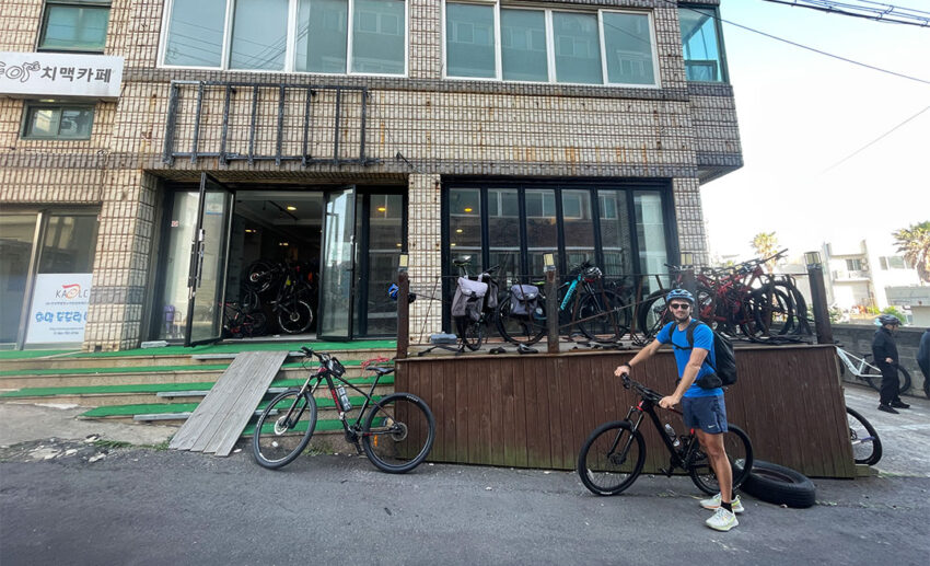 The exterior of a local bicycle rental shop in Jeju Island, showcasing a row of well-maintained touring bikes ready for long-distance trail riders.