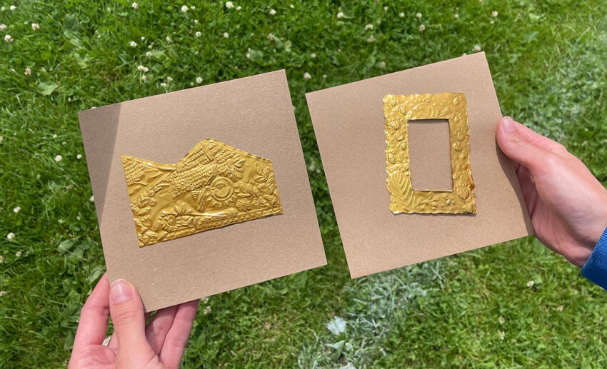Two women participating in a creative metal embossing craft workshop at a community fundraiser event in Brynaman, South Wales.