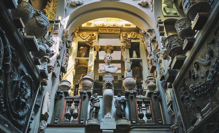 Intricate classical sculptures, architectural carvings and antiquities lining the narrow interior walls of Sir John Soane’s Museum in London.