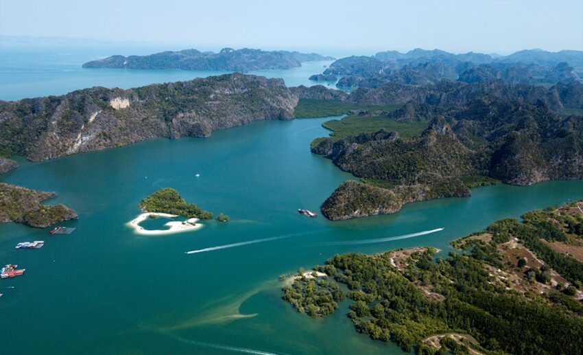 Ancient limestone karst formations and winding river waterways at the Kilim Geoforest Park in Langkawi, Kedah, perfect for slow nature travel.