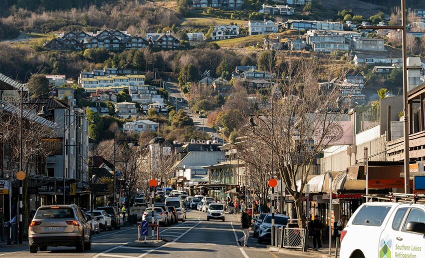 A scenic street view of a historic terraced town built onto a hillside, showing public spaces and residential neighbourhoods.