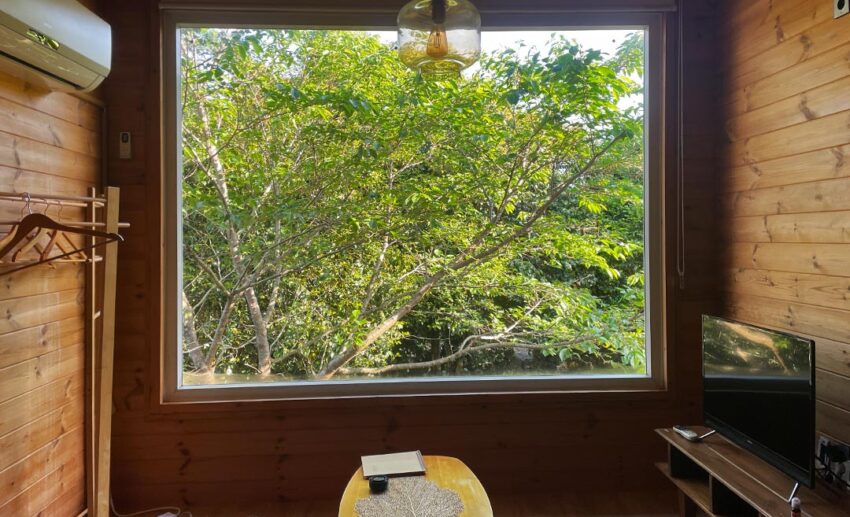 A warm, inviting traditional pension lodging on Jeju Island, showing a peaceful retreat space designed for relaxation.