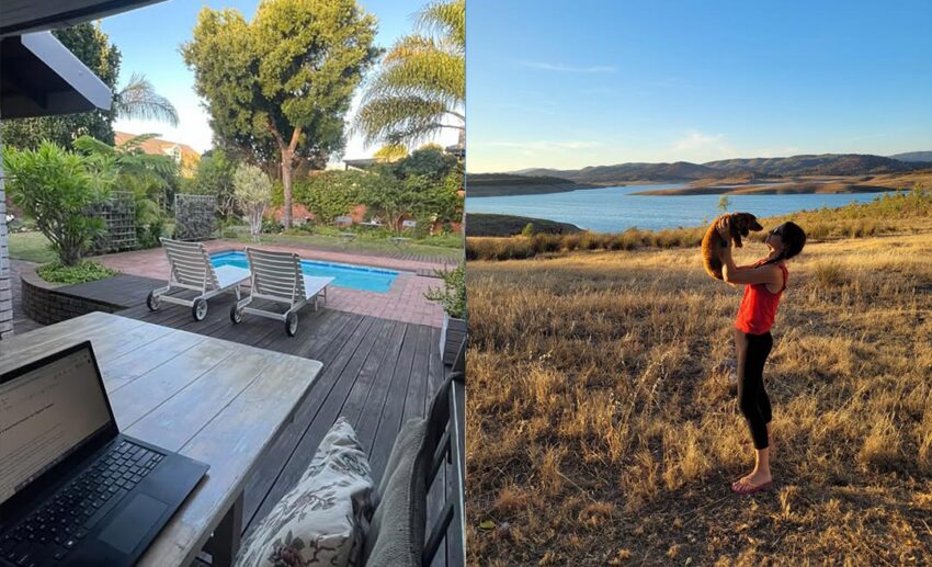 A digital nomad laptop setup on a South Africa patio next to a woman holding a small brown pet dog against a beautiful mountain lake landscape.