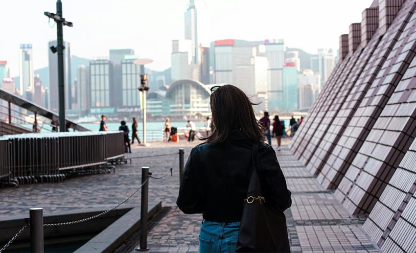 A woman walking towards a city skyline during a relaxed urban exploration