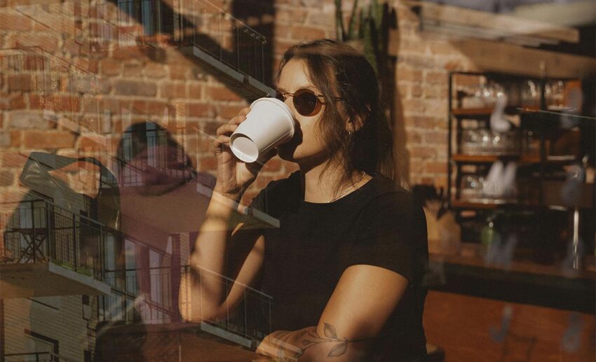 Double-exposure conceptual image of a woman drinking coffee blended with a classic urban residential building facade, representing temporary residency.