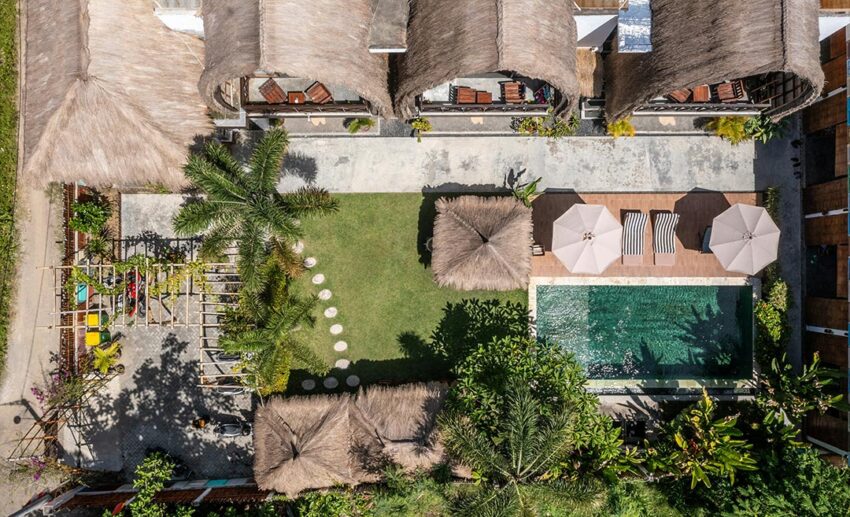 Aerial view of a boutique nature resort featuring private villas, swimming pool, and sun loungers