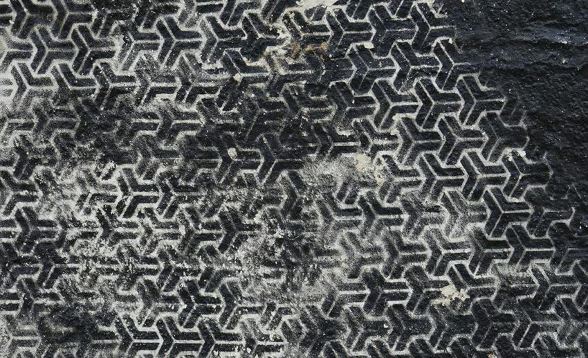 Overhead view of a black-and-white patterned rug showing detailed woven textile texture
