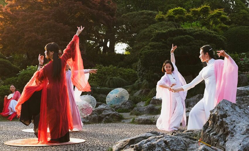 Women performing traditional dance in authentic cultural attire in Hangzhou, China.